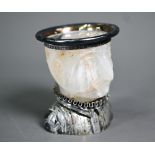 An antique Continental silver gilt novelty salt or mustard, the polished stone body carved as a