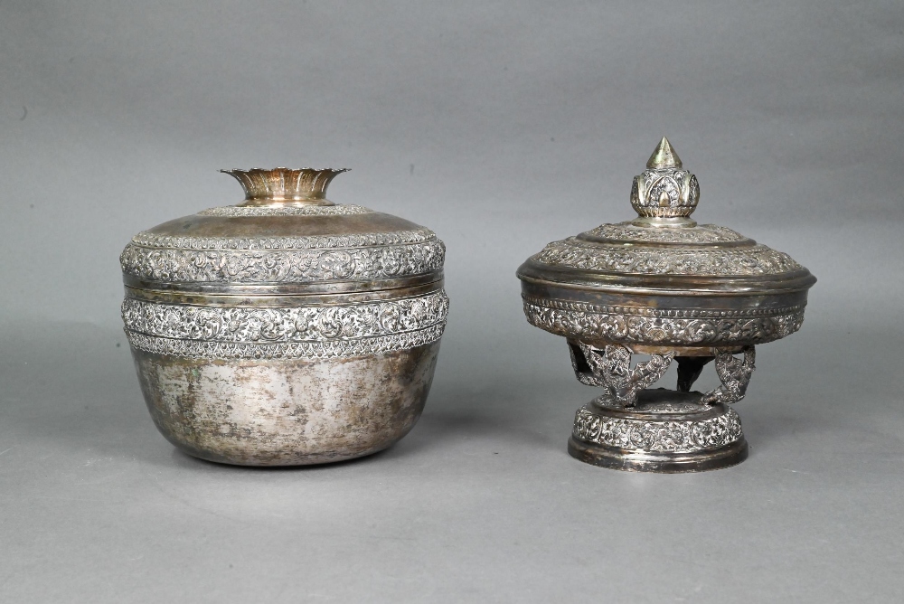 A South East Asian silver stem bowl and cover with lotus bud finial, profusely embossed and engraved