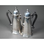 A silver cafe au lait pair in the Carolean manner, of octagonal tapering form with domed lids and