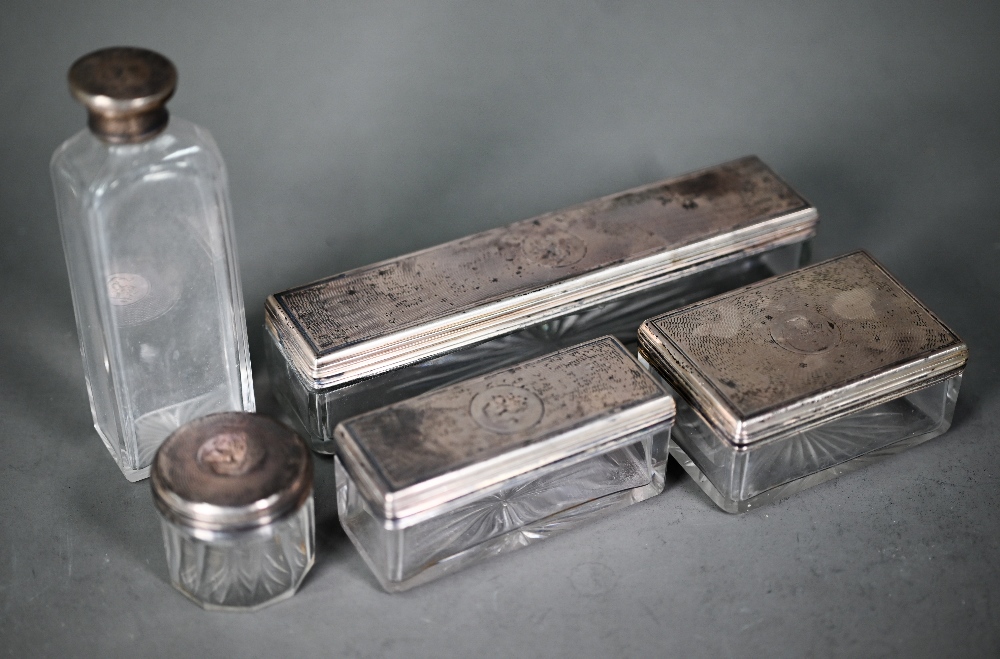 Five Victorian cut glass toilet jars with engraved silver tops (from a toilet-case), Frances