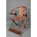 An antique brass mounted rosewood Chinese folding Emperor's style chair, with rope seat and