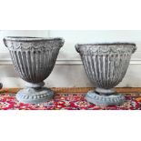 An antique pair of Adam style lead urns, 37 cm h (2) bodies showing some distortion, original