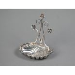 Edwardian silver watch stand with scrolling shamrock-embellished bracket and scalloped base,