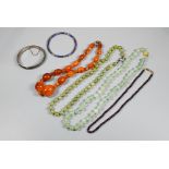 Row of graduated amber beads, two green aventurine bead necklaces, cloisonné bangle, silver oval