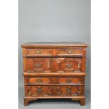 A Jacobean and later oak chest of 4 long drawers in two sections, the drawers with applied geometric