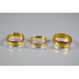 Three 22ct yellow gold wedding bands, size J, O, M, all distorted, approx 8.5 g (3)