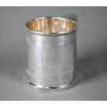 Silver Christening mug in the Georgian manner, of tapering form with reeded bands and scroll handle,