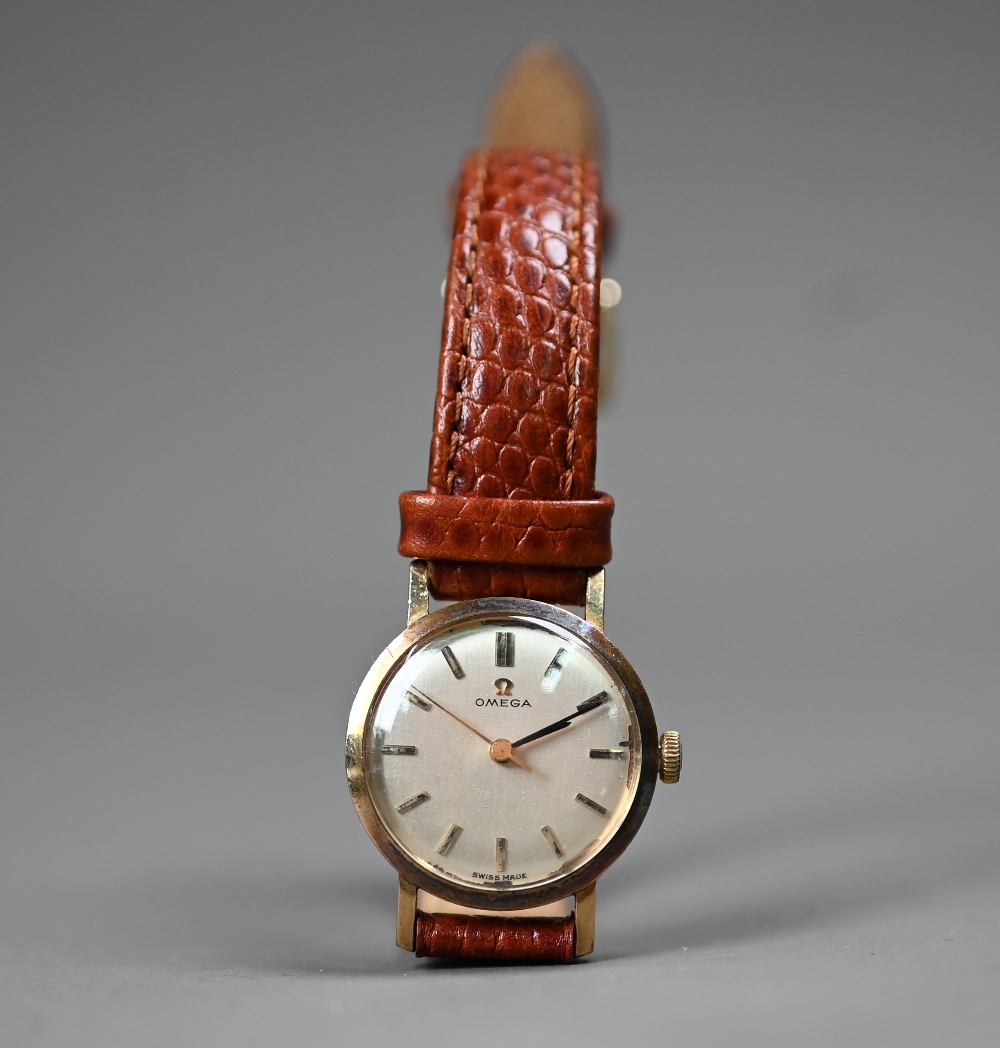 A vintage ladies Omega 9ct gold mechanical wristwatch on leather strap, circa 1967, the silvered