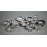 A late Victorian silver seven-piece condiment set (a/f), Sheffield 1896, to/w three napkin rings and