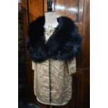A vintage black fur shoulder cape to/w a gold brocade jacket featuring small floral sprigs, with