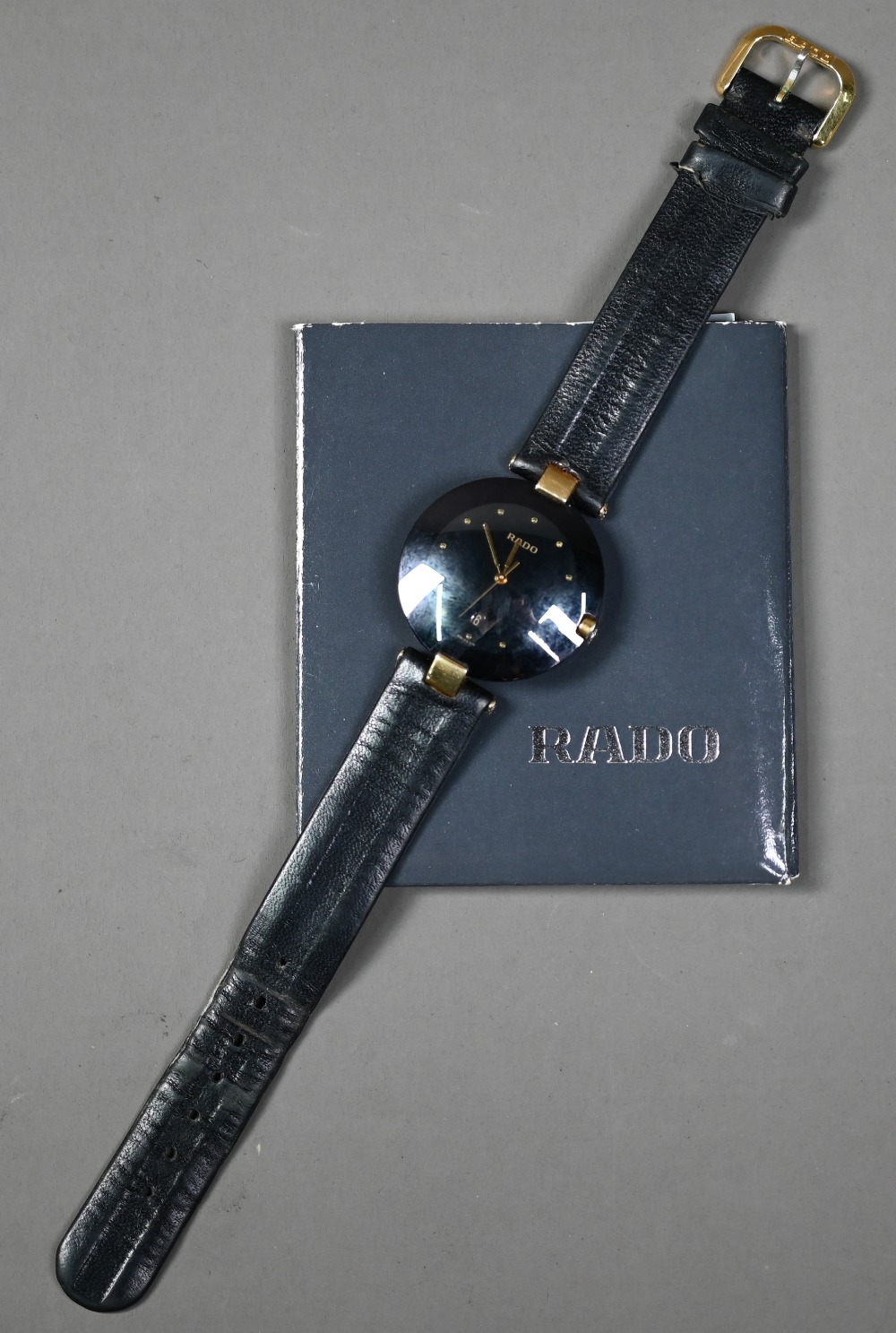WITHDRAWN A Rado Dia Star wristwatch, black dial and gilt, with black leather strap,