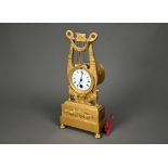 An antique Egyptian Revival ormolu mantel clock, the 8-day drum movement stamped CV 44, with (
