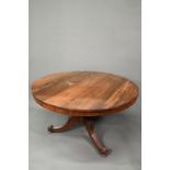 A Victorian rosewood breakfast table, the circular tilt top raised on four moulded swept legs to