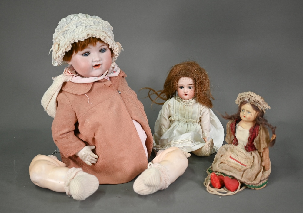 An Armand Marseille 990 A10M bisque-headed girl-doll with closing blue eyes and red wig, open