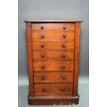 A Victorian mahogany Wellington chest of seven graduated drawers, with turned handles, raised on a