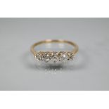 A graduated five stone diamond ring, the old cut diamonds in scroll claw mount, 9ct yellow gold set,