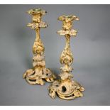 A pair of 19th century Rococo-revival ormolu candlesticks of ornate scrolling design, 25 cm high