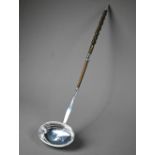 Georgian silver punch ladle with oval bowl and stem, the twisted whalebone handle with silver