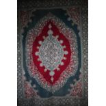 A good and large antique Kashmir crewel work carpet, first quarter 20th century, the soft red ground