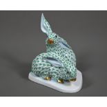 A Herend group of two hares, hand-painted and gilded with green scales, no. 5332, 14 cm high