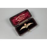 A yellow metal RAF wings brooch, with green and red enamelled details, stamped 9ct, 4.5 cm long,