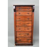 A Victorian rosewood seven drawer Wellington chest, each with twin turned knobs, raised on a