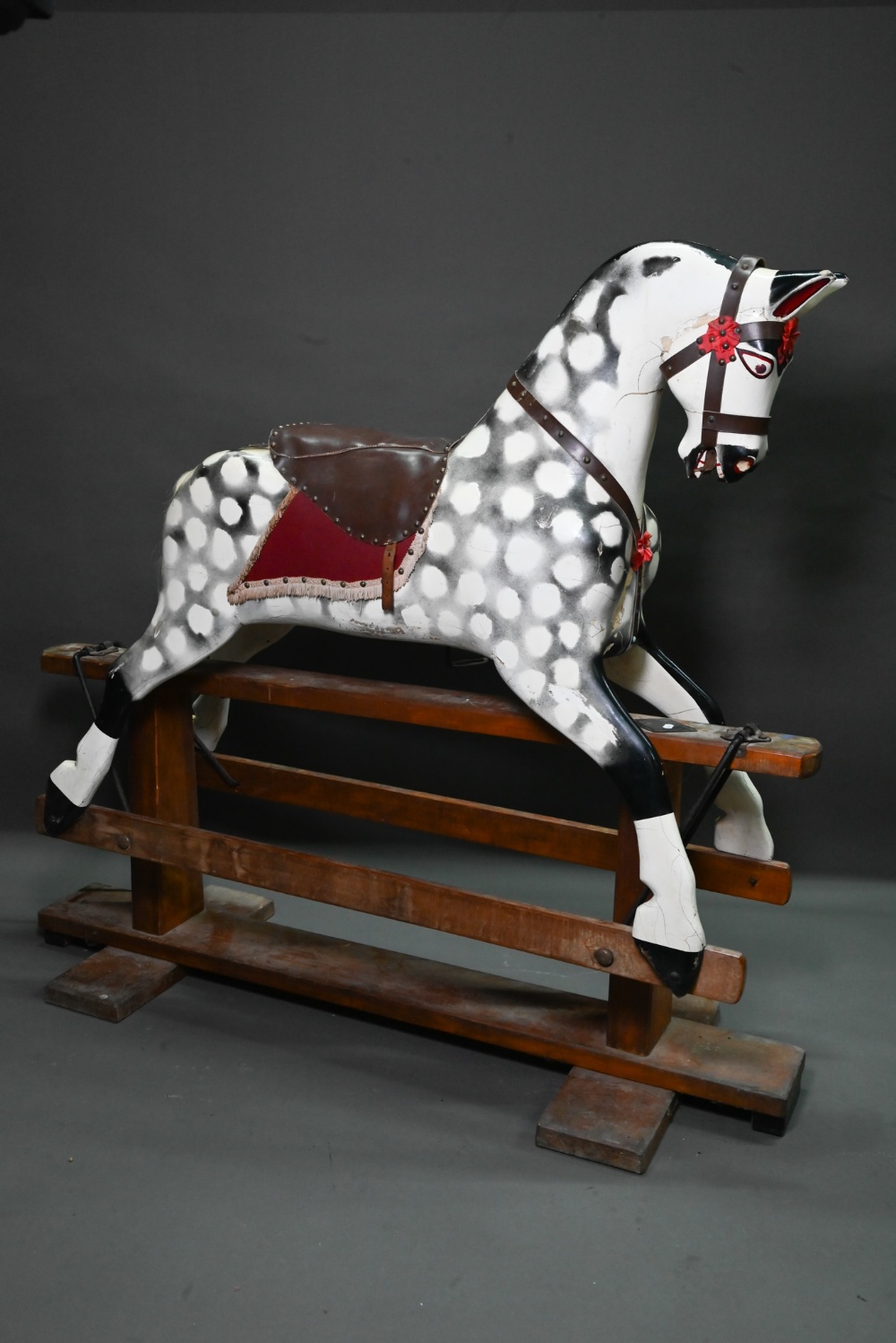 A large antique country house wooden rocking horse, (in later dapple grey finish), with remnants