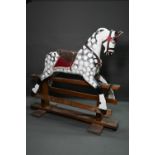 A large antique country house wooden rocking horse, (in later dapple grey finish), with remnants