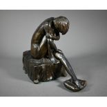 A bronze-patinated spelter figure, female nude study, seated on a square plinth, unsigned, 23cm high