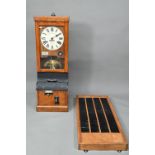 The National Time Recording Co. Ltd, a vintage oak cased time clock, with card slots and key, 98