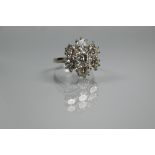 A diamond cluster ring with six round brilliant cut diamonds surrounding a central round brilliant