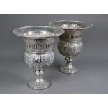 A pair of Continental electroplated champagne ice-buckets in the form of campana urns on stemmed