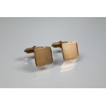 A pair of 9ct yellow gold cufflinks of square design with engine-turned decoration, with swivel