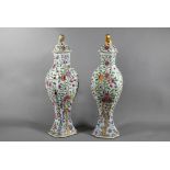 A pair of 18th century Chinese famille rose garniture vases and covers with gilded animal finials,