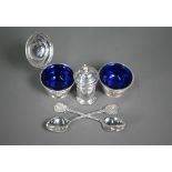 A silver three-piece condiment set with blue glass liners, Birmingham 1932, to/w a pair of Dunstable