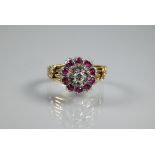 A diamond and ruby cluster ring, the cluster in the form of petals set with central diamond