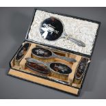 A cased silver and tortoiseshell six piece brush set with pique-work decoration, London 1915, to/w