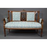 An Edwardian walnut framed salon sofa, the back centred by a lyre splat flanked by fabric backrests,