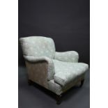 An early 20th century easy armchair by Howard, in original green monogramed ticking, raised on