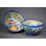 A graduated pair of 19th century Italian majolica bowls, painted with a boar and a bull in
