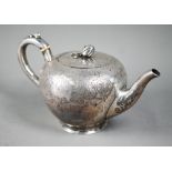 A Victorian silver bullet-shaped teapot with melon finial and engraved decoration, ivory insulators,