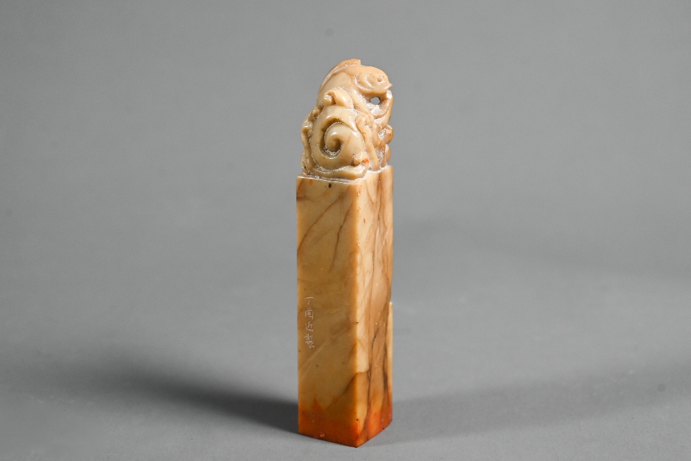 A Chinese butterscotch coloured soapstone seal carved with a carp and wave finial, four character - Image 2 of 6