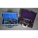 A vintage cased Buisson (Paris) rosewood clarinet to/w a Boosey & Hawkes plastic clarinet (2)