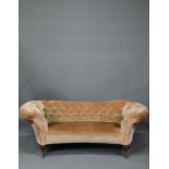 A Victorian button upholstered sofa, raised on moulded and turned walnut front lets, on ceramic