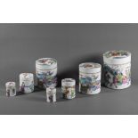 A set of four Chinese 19th century famille rose nesting lidded boxes of cylindrical form, painted in