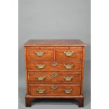 A good reproduction George II style feather-banded chest of drawers, the full width brush slide over