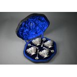 A good cased set of four Victorian silver oval open salts with shaped rims, ornately embossed and