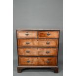 An 18th century cross-banded walnut chest of two short over three long graduated drawers, raised