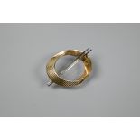 A 9ct yellow gold stylised oval brooch of ribbed and plain design, with two white metal rods