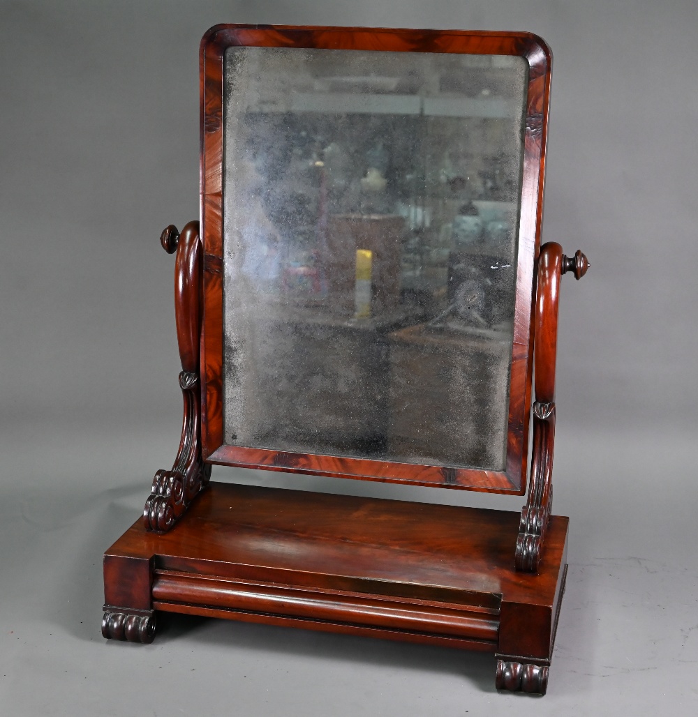 A Georgian mahogany toilet mirror, on single drawer platform base, raised on moulded scroll feet,